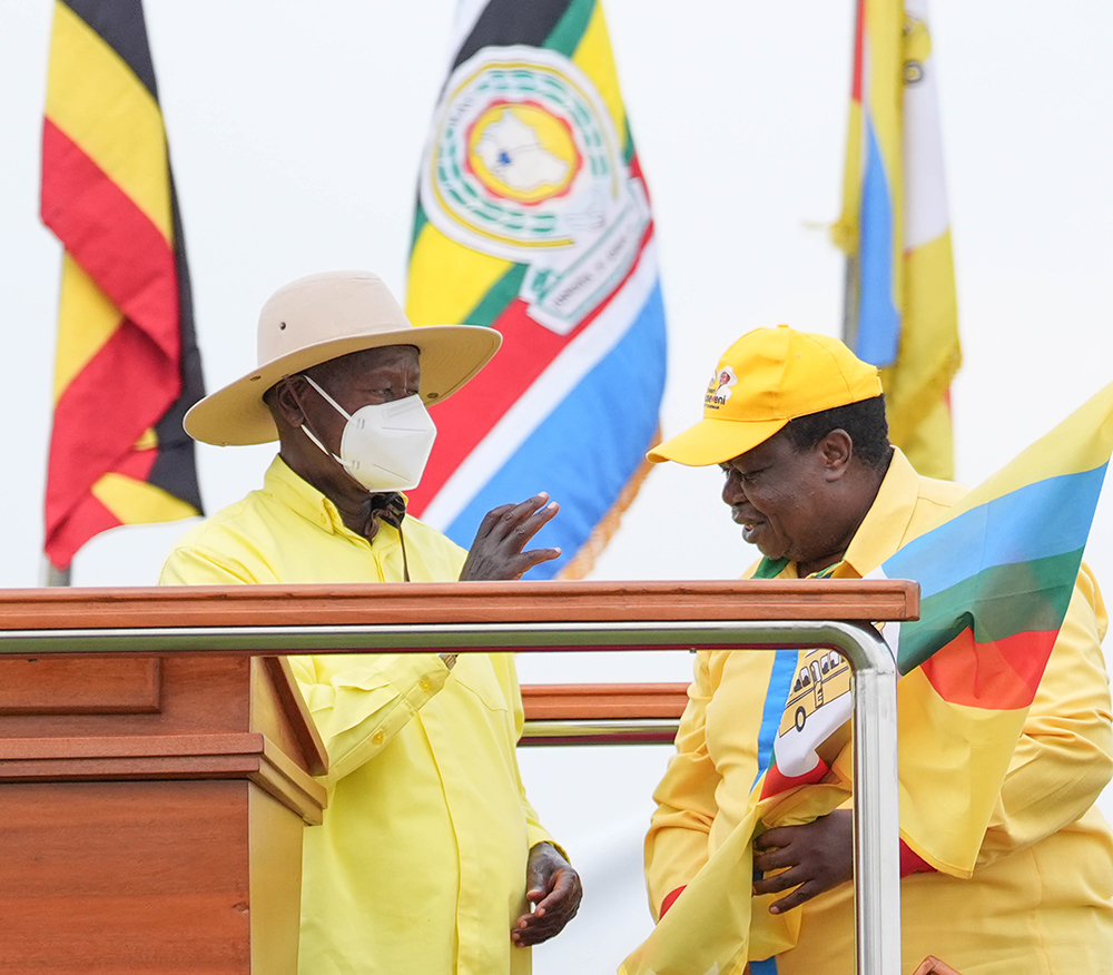 Internal affairs minister Gen. Kahinda Otafiire receiving the NRM flag from president Museveni. (PPU)