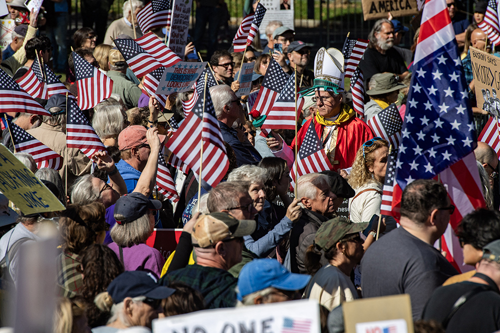 People participate in a "No Kings" national day of protest in Boston, Massachusetts, on October 18, 2025. From New York to San Francisco, millions of Americans are expected to hit the streets to voice their anger over President Donald Trump's policies at nationwide "No Kings" protests. 