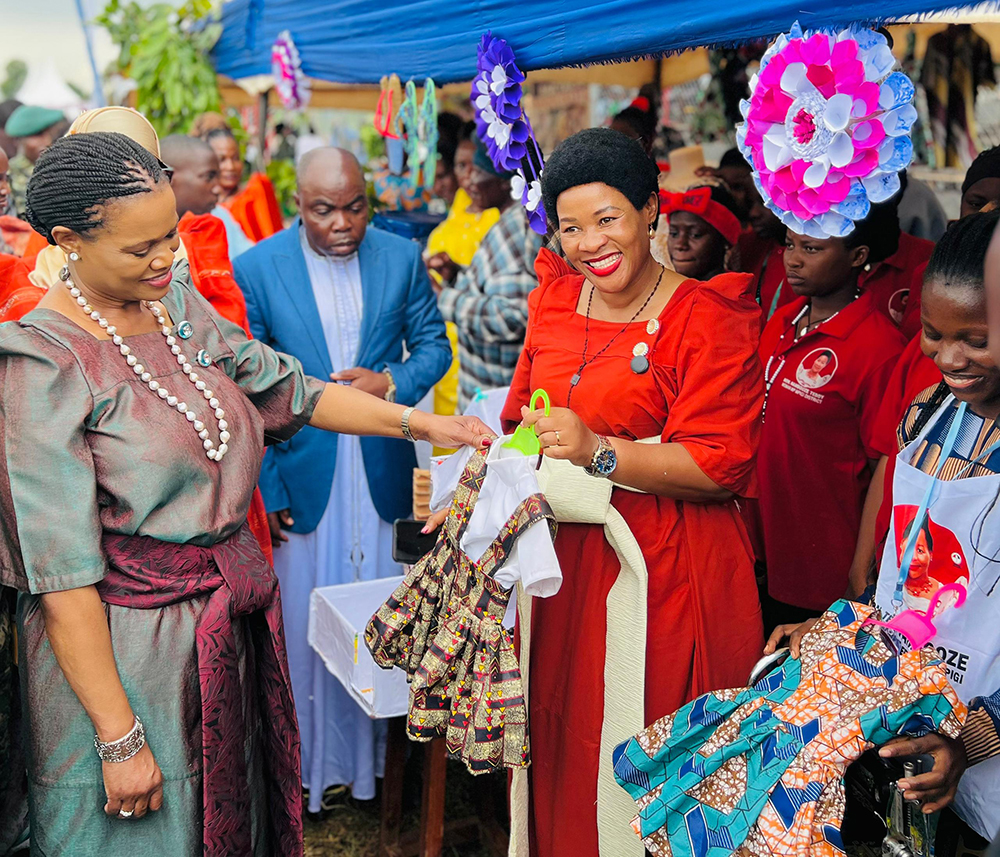 Nnaabagereka admiring some of the clothes by exhibitors as Nambooze looks on. (Courtesy)
