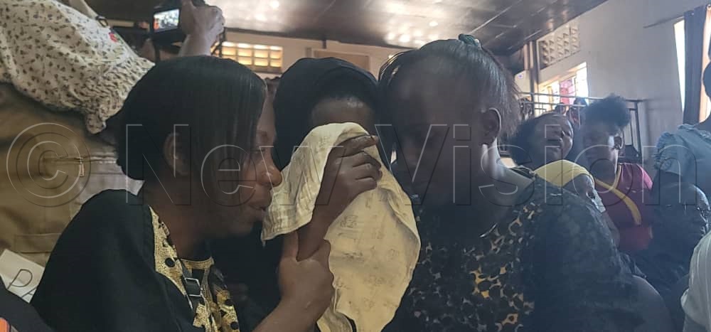 One of the Mourners being consoled by fellow mourners. (Credit: Stuart Yiga)