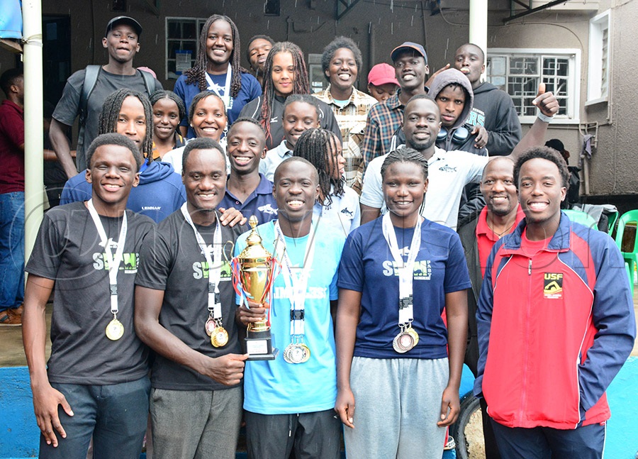 The Makerere University swimming team pose with their trophy and medals after the the first inter-university swimming gala at the British School Kampala. Photo by Michael Nsubuga