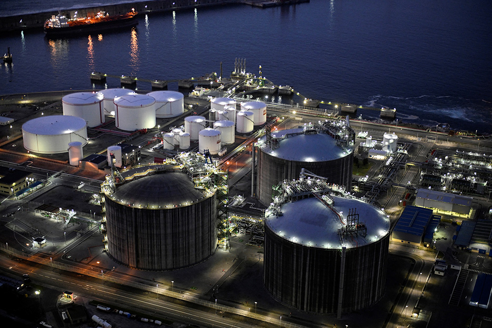 A picture taken at sunset on March 12, 2026 shows a general view of the Bizkaia Bay Gas (BBG) regasification plant in the Spanish Basque city of Zierbena. (Photo by ANDER GILLENEA / AFP)