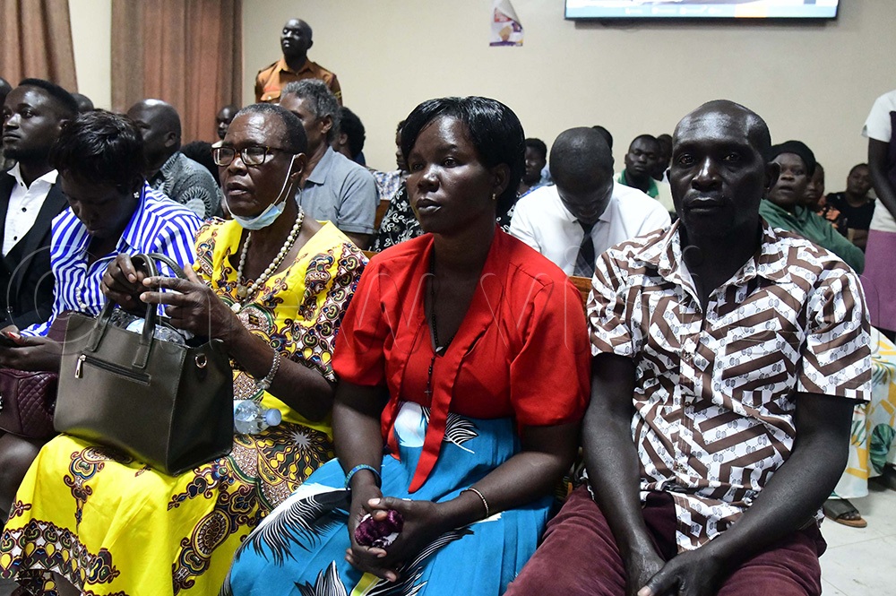 Faith Angel Akol, the mother of the slain five-year-old Joan Faith Apio, on a red top in the middle with relatives in court. (Photo by Godfrey Ojore)