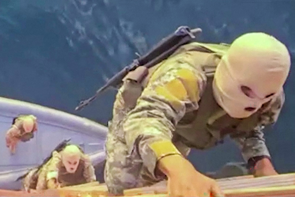 This screen grab taken from undated video footage released by Iran's Revolutionary Guards (IRGC) and made available via Iran's state broadcaster (IRIB) on April 23, 2026, shows IRGC naval forces allegedly boarding a ship attempting to cross the Strait of Hormuz. 