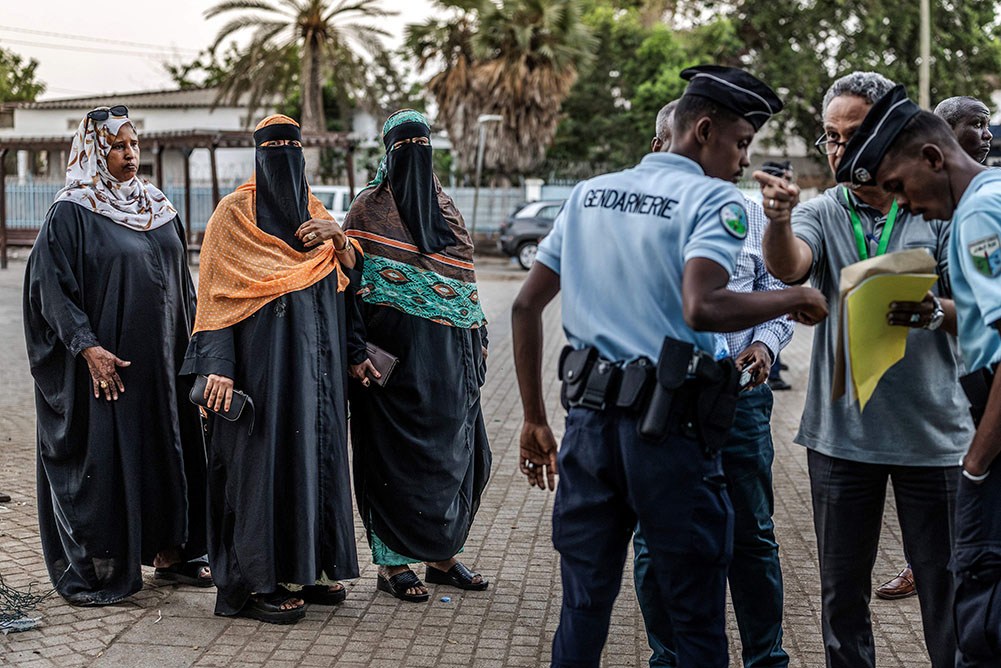  Members of the Djiboutian gendarmerie monitor access to a polling station as voters and officials gather amid delays in the opening of polls at a primary school serving as a polling station in Djibouti, on April 10, 2026, during the 2026 Djiboutian presidential elections. (Credit: AFP)