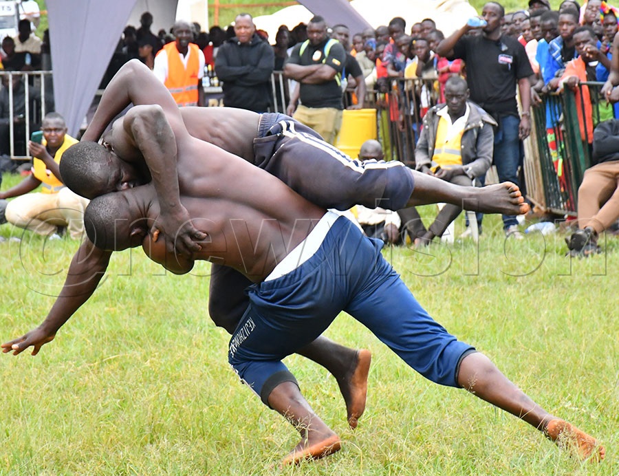 Local wrestlers competing during the 4th edition of the Ekigwo Naisoloza at Ekitudha Konta Nkonte concert in Kyabazinga Stadium .  Photo by Donald Kiirya