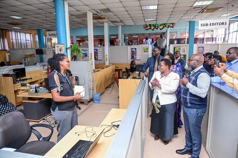 Vision Group's Penlope Nankunda (L), the Content Manager Digital Hub (Content Generation) greets officials as they toured Vision Group.