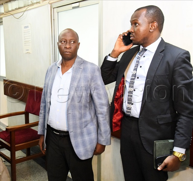  Commissioner Land Registration Baker Mugaino (L) and his lawyer at the Inspectorate of Government (IG). (All Photos by Mpalanyi Ssentongo)