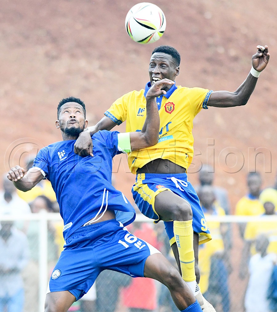 Police FC's Saidi Kyeyune (left) battles for the ball with KCCA FC's Derrick Nsibambi during a Uganda Premier League match at Kira Police Ground. Photo by Michael Nsubuga