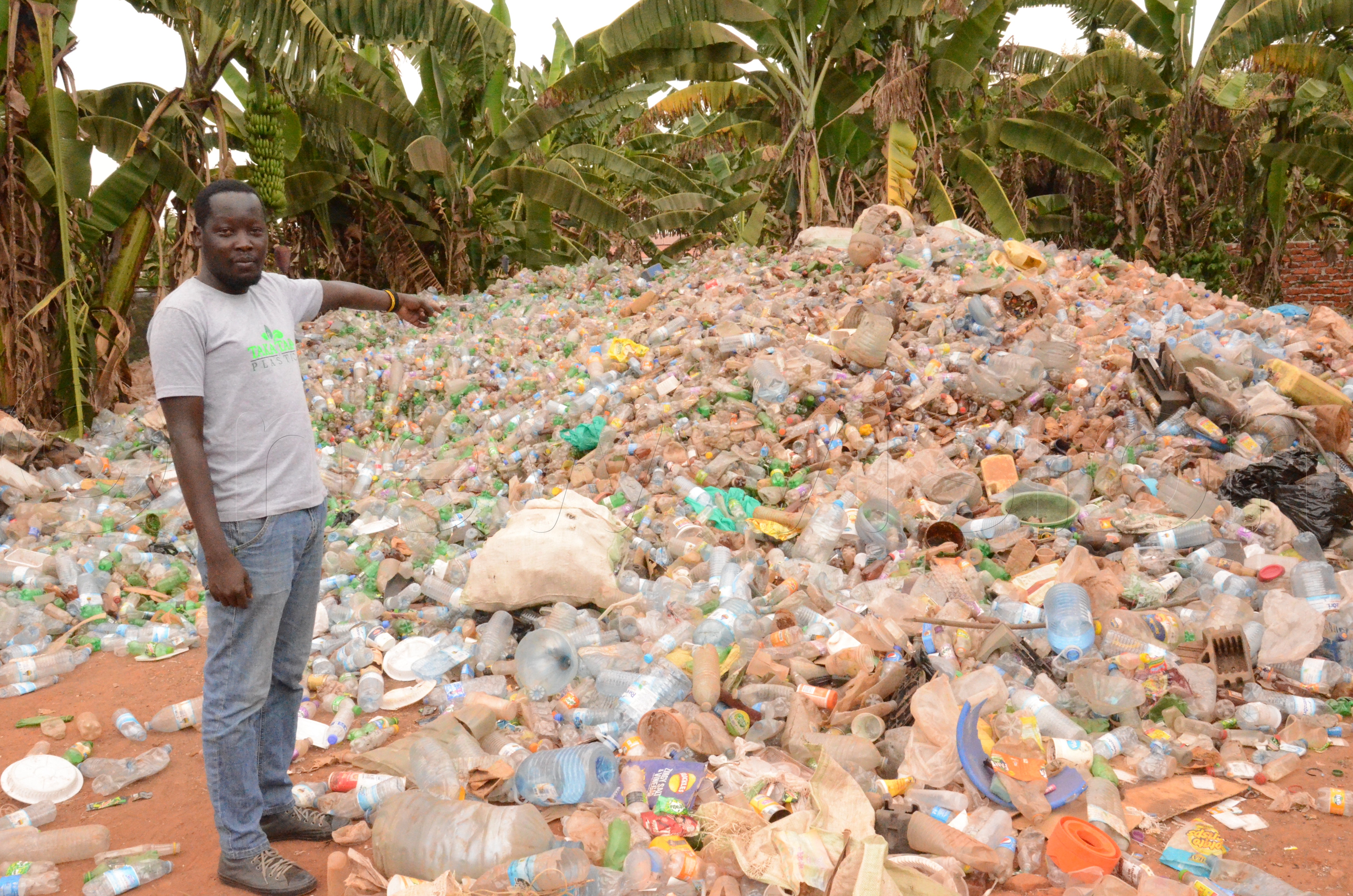 Peter Okwoko, a co-founder and chief operating officer Takataka plastics showing used plastic bottles that they have collected to run theyr recycle industry.