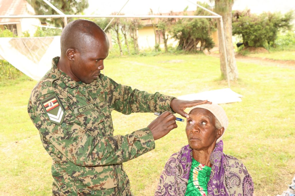 An elder being check by UPDF eye specialist during the 45th Tarehe Sita medical camp at Kashambya health centre III Rukiga district. (Courtesy)