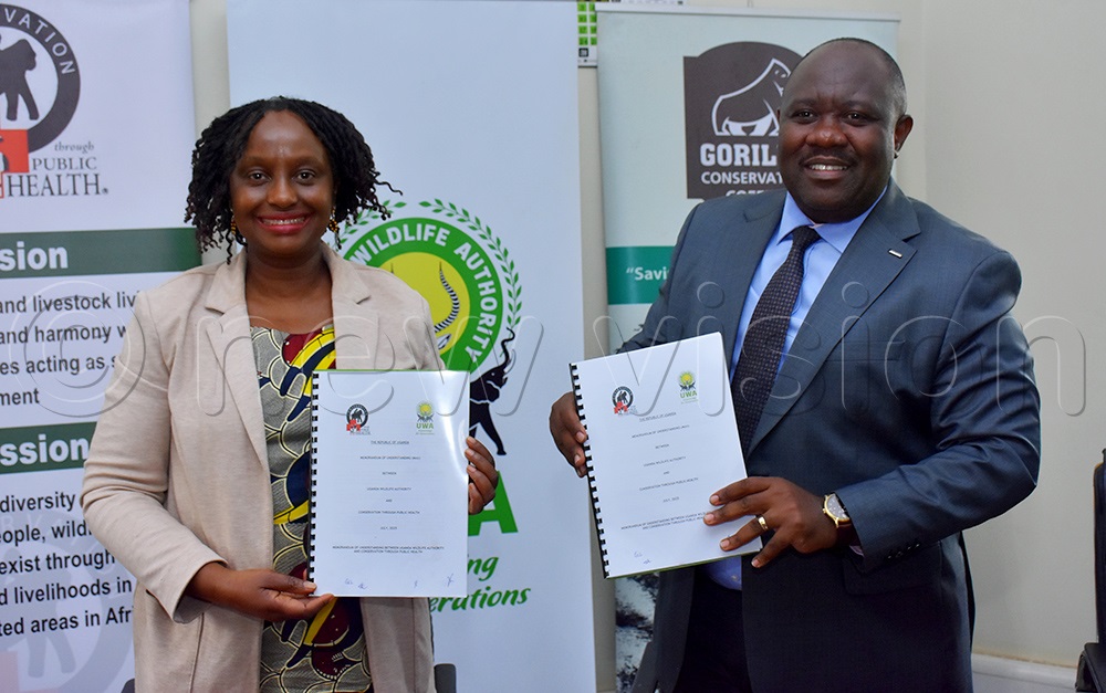 Dr Gladys Kalema and Dr James Musinguzi after renewing a memorandum of understanding between the Uganda Wildlife Authority and the Conservation Through Public Health at UWA headquarters in Kampala. (Photo by Julius Luwemba)