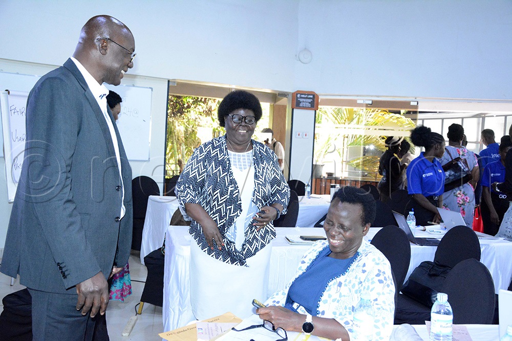 (L-R) Okuni Akim Head Welfare Development interacting with Rita Laura Lulua Program Head Education Systems and Kedrace Turyagyenda Permanent Secretary for the Ministry of Education and Sports during human development programme review meeting. (Photo by Mary Kansiime)