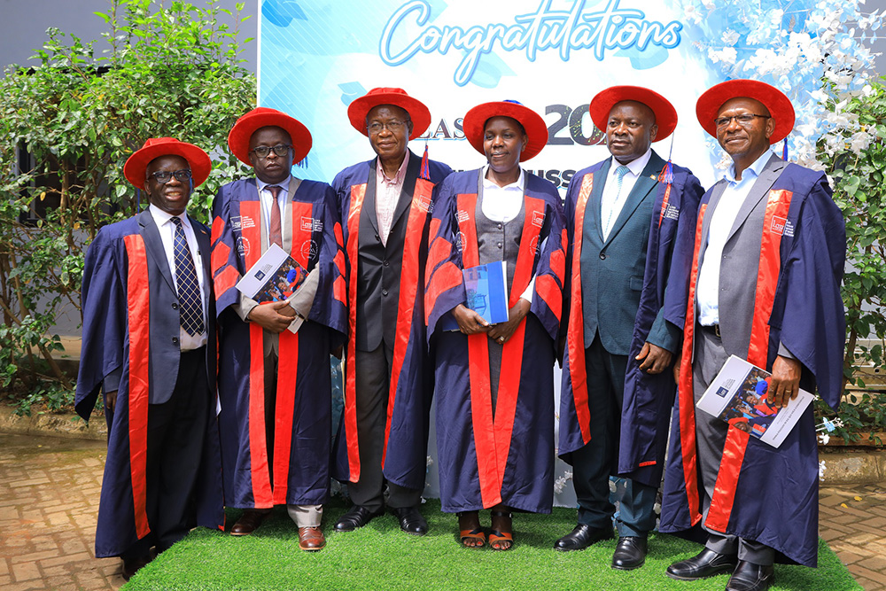 Guest of honour Dr Cleophus Mugenyi (second right) with Luigi Giussani Institute of Higher Education (LGIHE) principal, Stella Rose Akongo (third right) and other officials pose for a photo after graduation. (Courtesy photo)