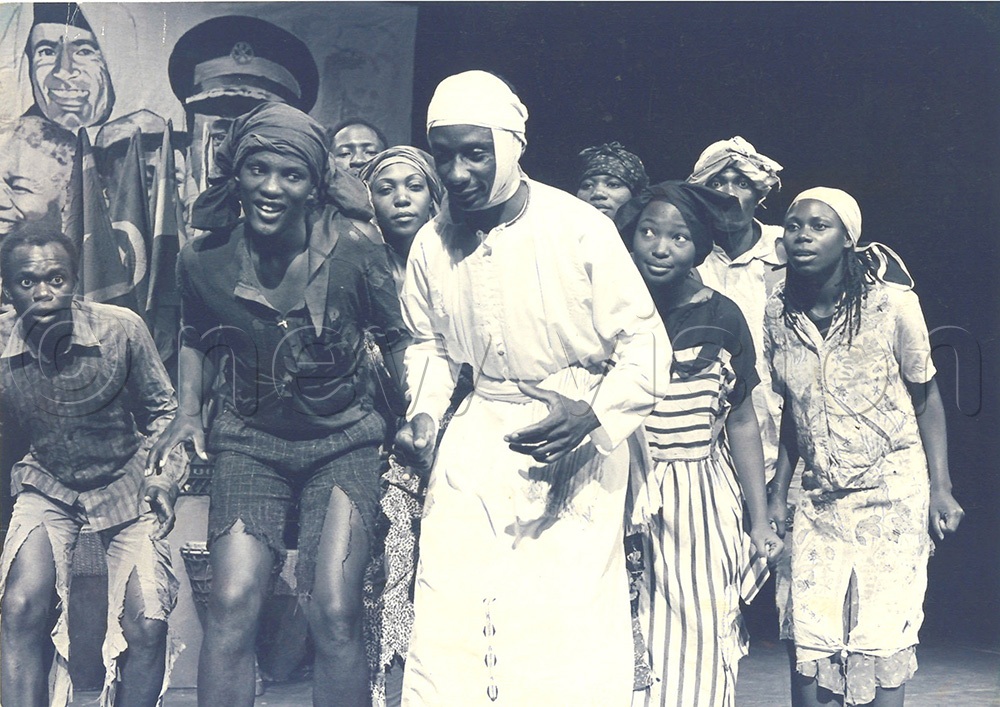 Alex Mukulu in white Kanzu in action with Concern International in ‘Wounds of Africa during their tour to the US, 15th May 1994. (Credit: New Vision Archives)