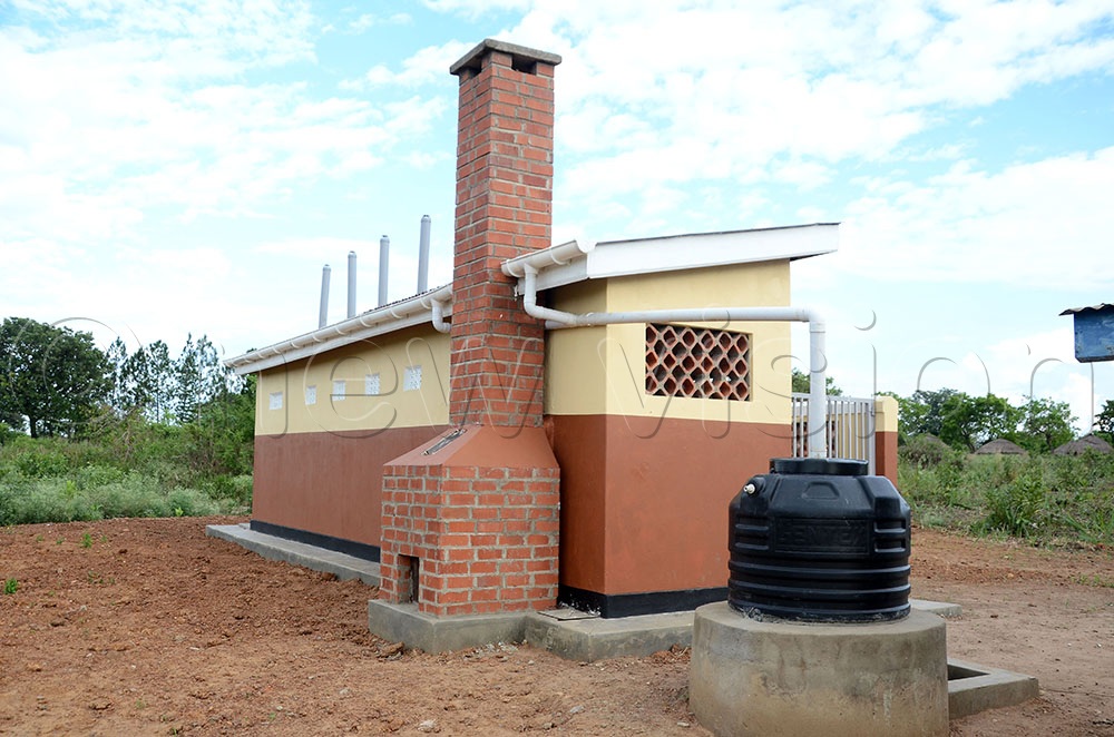 A side view of a improved latrine that was installed at Odum Primary School in Puranga sub county Pader district under the One Health Project. The latrine, one of those constructed by Amref Health Africa in Pader district schools has a changing room, an insinerator and water connected to it to improve sanitation and hygine of pupils.  (Credit: Lawrence Mulondo)