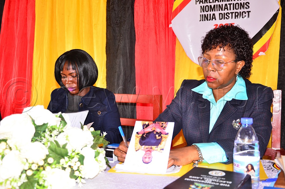 Jinja district returning officer, Sarah Catherine Kabukaire (R) and another official during the nomination exercise at Kagoma town council headquarters in Jinja district. (Photo by Jackie Nambogga)