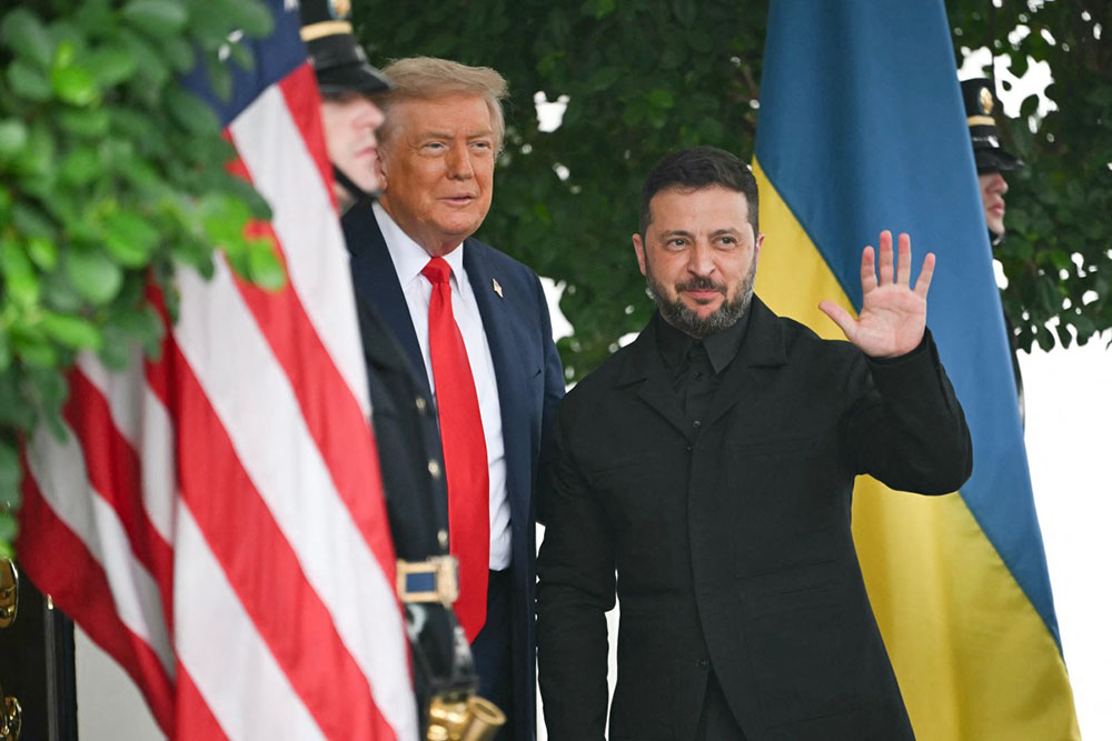 Ukrainian President Volodymyr Zelensky is greeted by US President Donald Trump (L) upon arrival at the White House West Wing in Washington, DC, on August 18, 2025. (Photo by ANDREW CABALLERO-REYNOLDS / AFP)