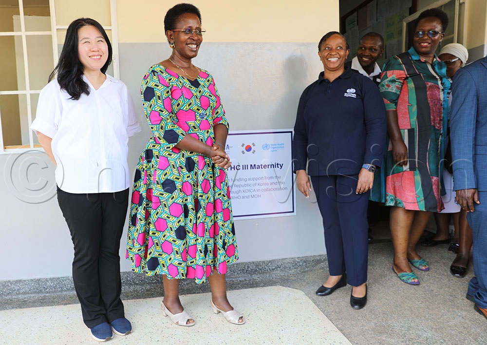 The Health Ministry's Permanent Secretary, Dr Diana Atwine, commissions Bulamagi Health Centre III, flanked by WHO and KOICA officials. Credit: Agnes Kyotalengerire)