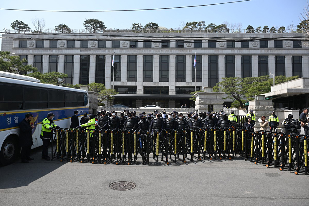 Riot police stand gaurd outside the Constitutional Court following the court's verdict on President Yoon Suk Yeol's impeachment outside the court in Seoul on April 4, 2025. AFP Photo