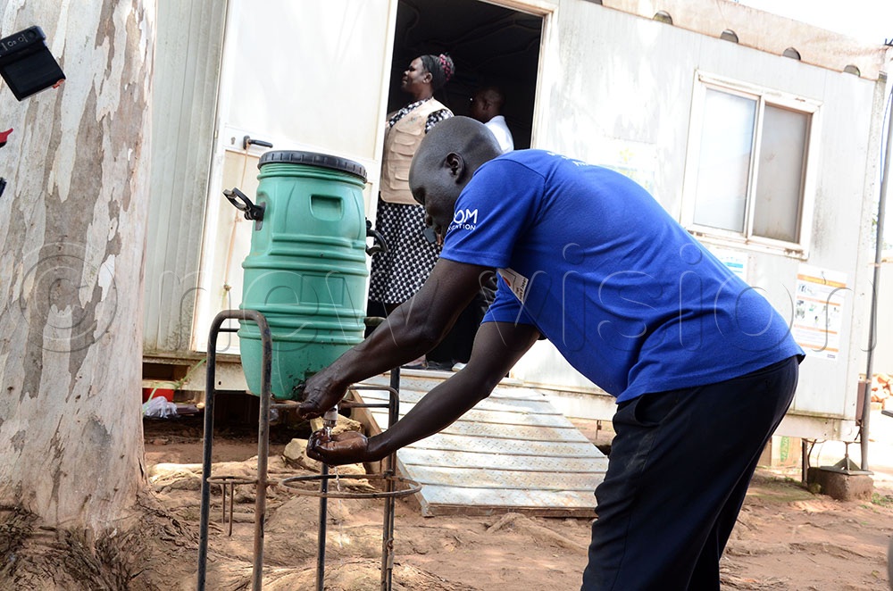 Emmanuel Andama the Point Of Entry In Charge at the Vurra border post in Arua district washing his hands before accessing his work station. The government has intensified surveillance and screening at Uganda's border points with the Democratic Republic of Congo (DRC) as part of efforts to prevent the spread of the Ebola Bundibugyo virus. This was on June 6, 2026. (Credit: Lawrence Mulondo)