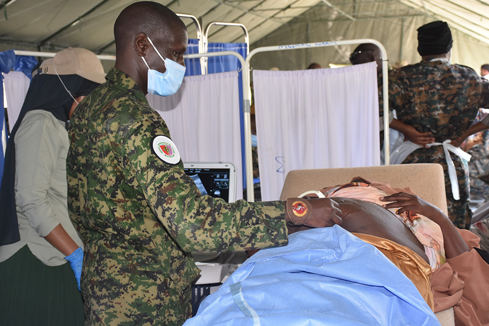A medical personnel conducting a scan on a patient. (Credit: UPDF)