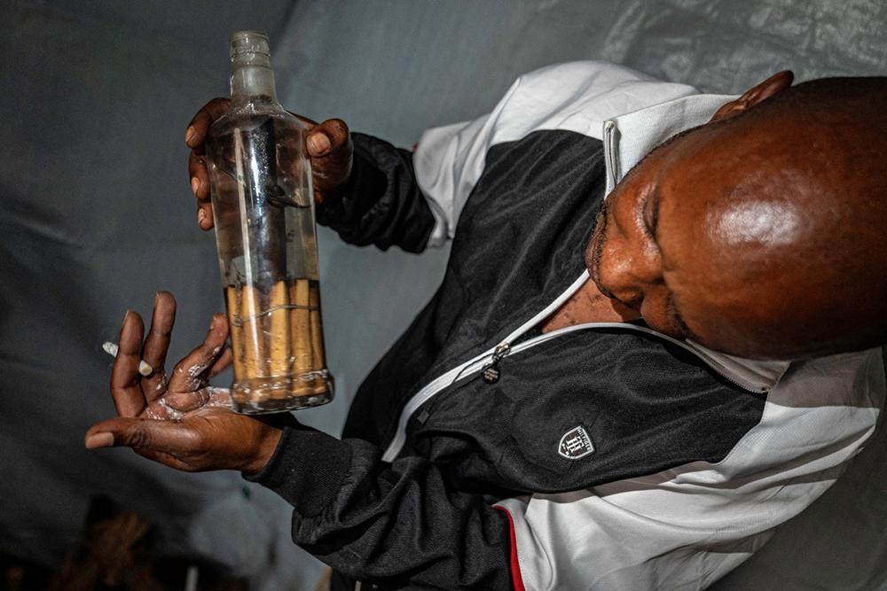 Dauda Tshimanga holds a bottle of traditional medicine in his laboratory in Bunia, in the eastern Democratic Republic of the Congo, on June 2, 2026. 