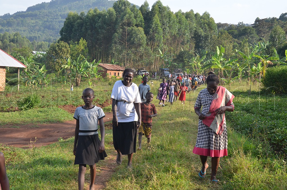 Locals walking during Muntu's campaign trail. (Photo by Isaac Nuwagaba)