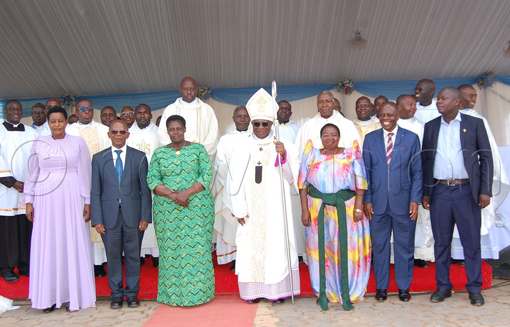 Archbishop Paul Ssemogerere (holding a crosier) shares a photo moment with the Vice-Persident, Jessica Alupo (on the archbishop's immediate right), Premier Robinah Nabbanja (third-right), Dr. Anthony Wamala (on premier Nabbanja's immediate left), Dr. John Chrysostom Muyingo (fourth-right), Justine Mbabazi (second-left), Moses Bagala (right) and the Catholic priests after the thanksgiving mass of the celebration of the 25th anniversary of Mount Sion Prayer Centre, Bukalango at the prayer centre on Hoima Road, in Kakiri Town Councill, Wakiso district on Sunday, April 19, 2026. (Photo by Mathias Mazinga)