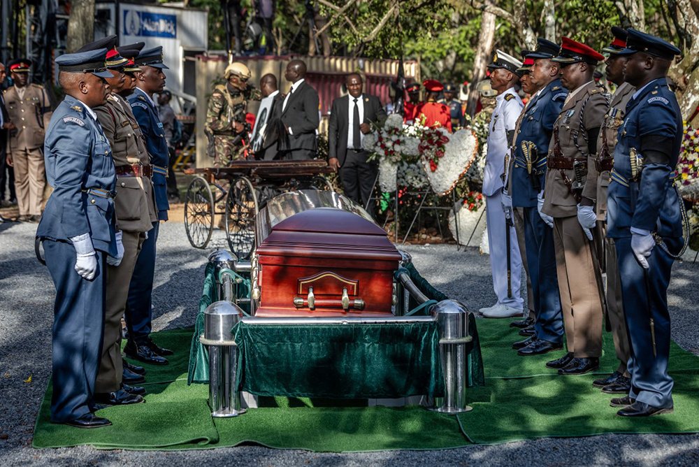 Senior military officials serving as pallbearers stand before the coffin of Kenya’s opposition leader and former Prime Minister Raila Odinga as he receives military honours during his burial ceremony in Bondo, on October 19, 2025. 