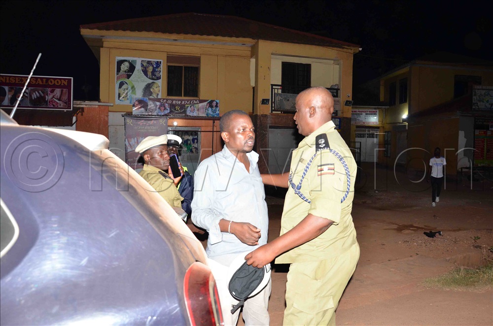 Kampala Metropolitan South Regional Traffic Officer, Godfrey Mwesigye (right) arresting Joshua</div></div></div></div><div class=