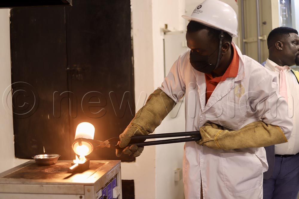 An expert from EuroGold refineries showing how gold is refined. (Credit: John Musenze)