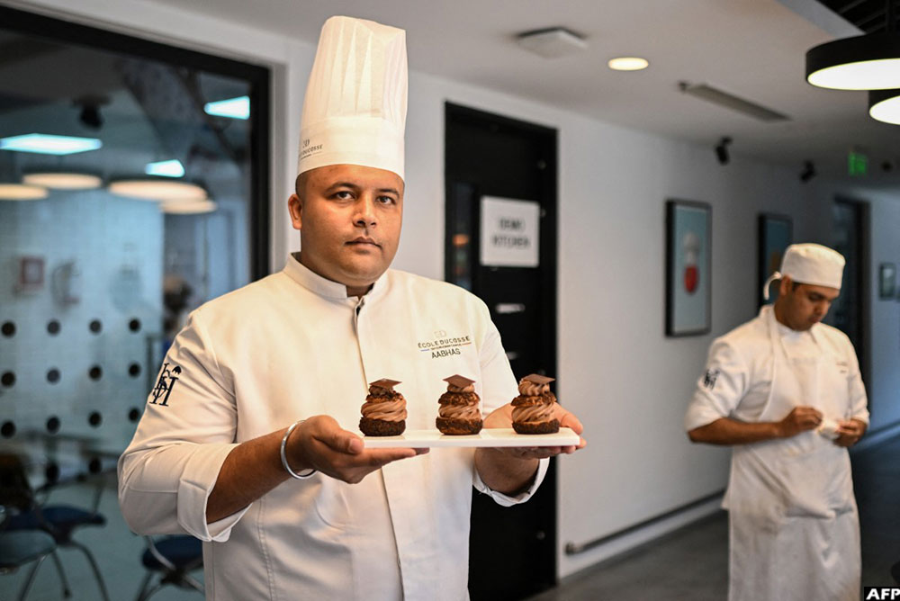 Bakery and pastry training director Aabhas Jain posing with a plate of pastries at the &Eacute;cole Ducasse, a French culinary school in Gurugram