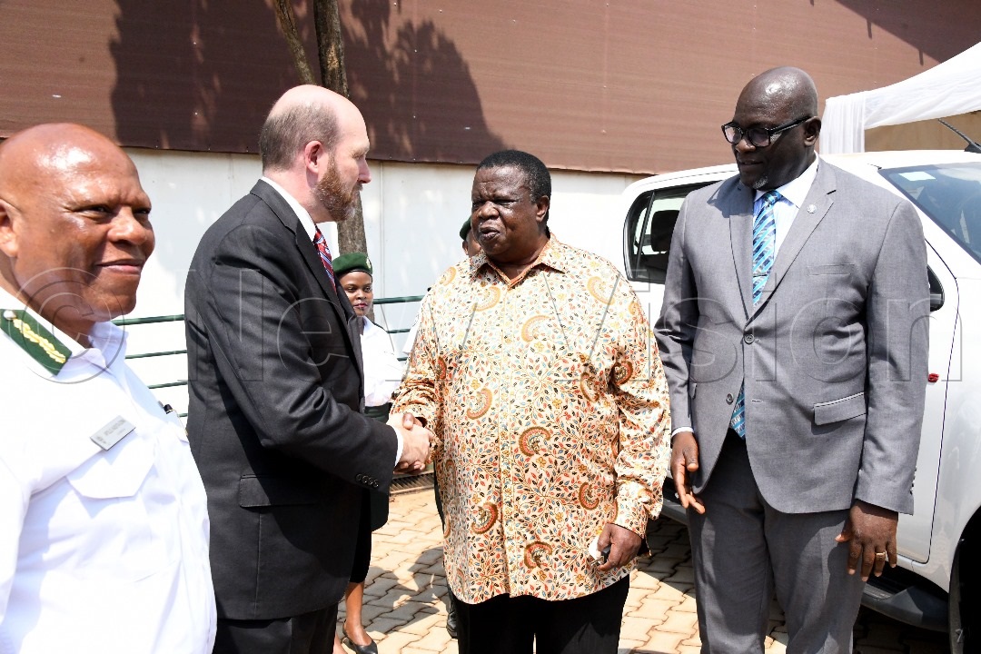 The US Ambassador to Uganda, William W. Popp shaking hands with Minister for Internal Affairs Maj. Gen. Kahinda Otafiire.