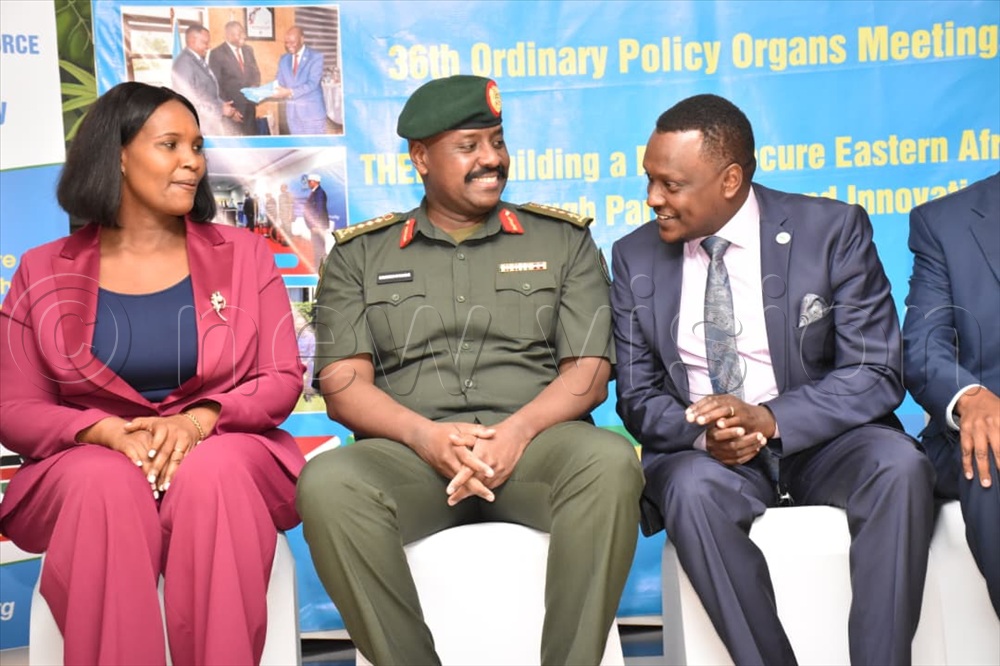 Grace Ngabirano looking on as Gen. Muhoozi shares a moment with Eastern Africa Standby Force (EASF) director Brigadier General Ronald Rwivanga