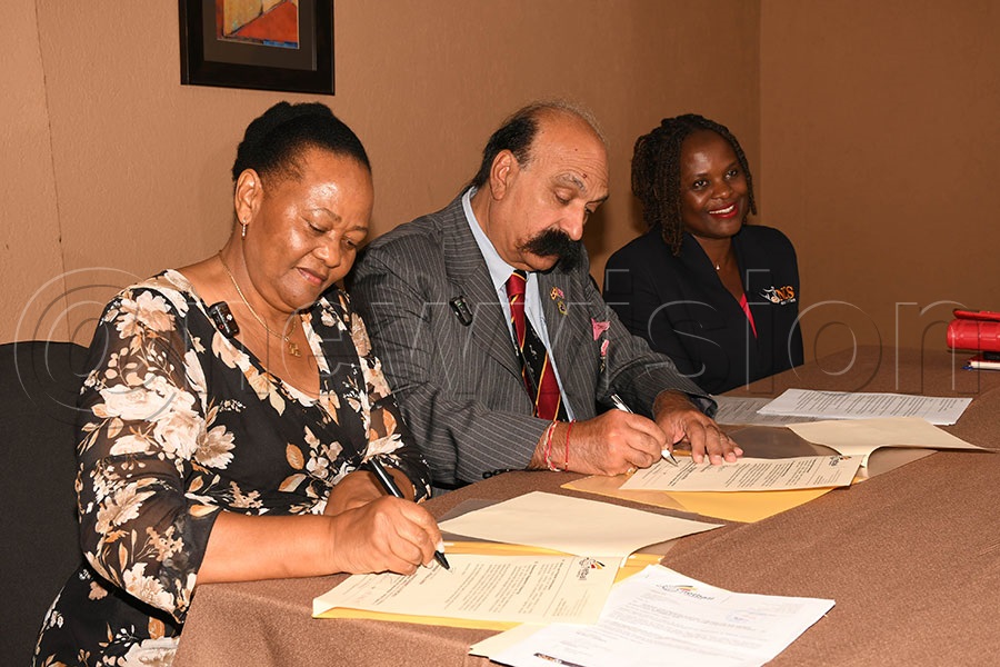 Netball Uganda president Jocelyn Ucanda (left) and Dr. Manoj Joshi MBE DL sign the agreement at Kabira Country Club, September 14, 2025. Photo by Michael Nsubuga