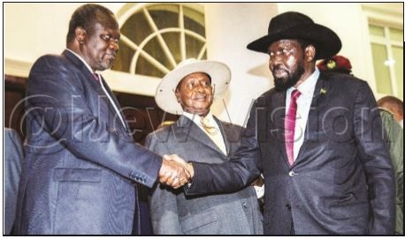 President Salva Kiir shakes hands with Riek Machar while President Yoweri Museveni looks on, following talks at State House, Entebbe in July 2018President 