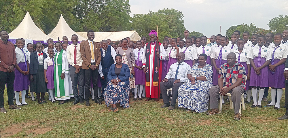 Bishop Kosea Odongo poses for a group photo with students, parents, and other stakeholders. (Photo by Juliet Akello)