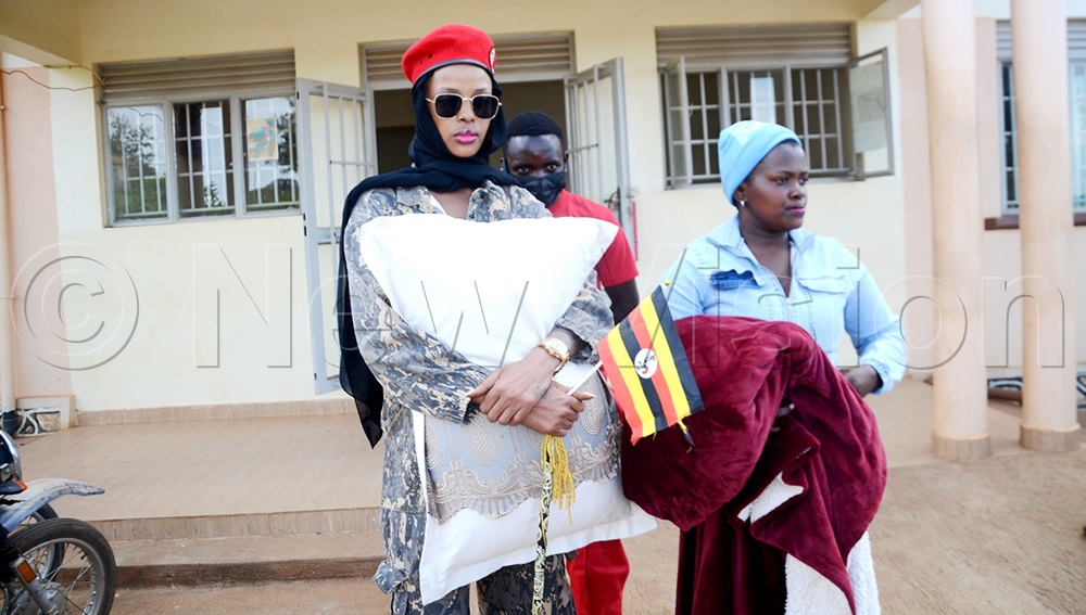 Nina Rose Kakunda, the NUP flag bearer for Ssembabule district woman Parliamentary candidate, with her relatives at Ssembabule CPS, where her father, Matia Shemereire, was arrested in connection with cattle thefts. (Photo by Dismus Buregyeya)