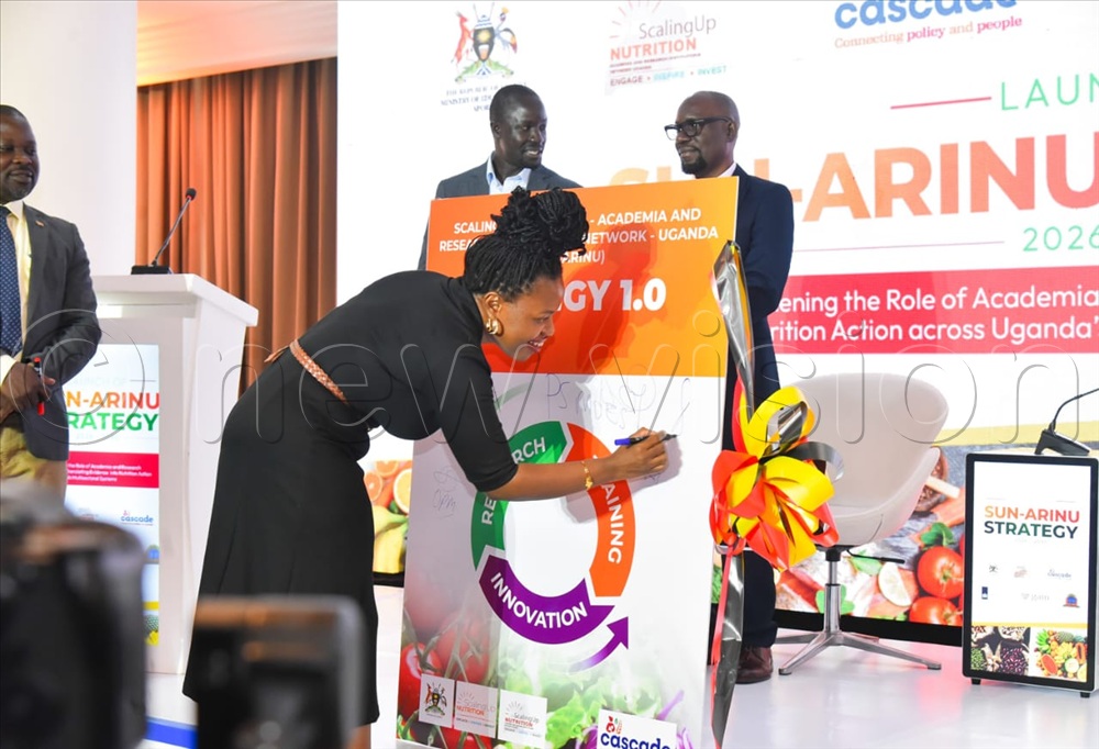Damali Ssali, the Gain Country Director signing the strategy.