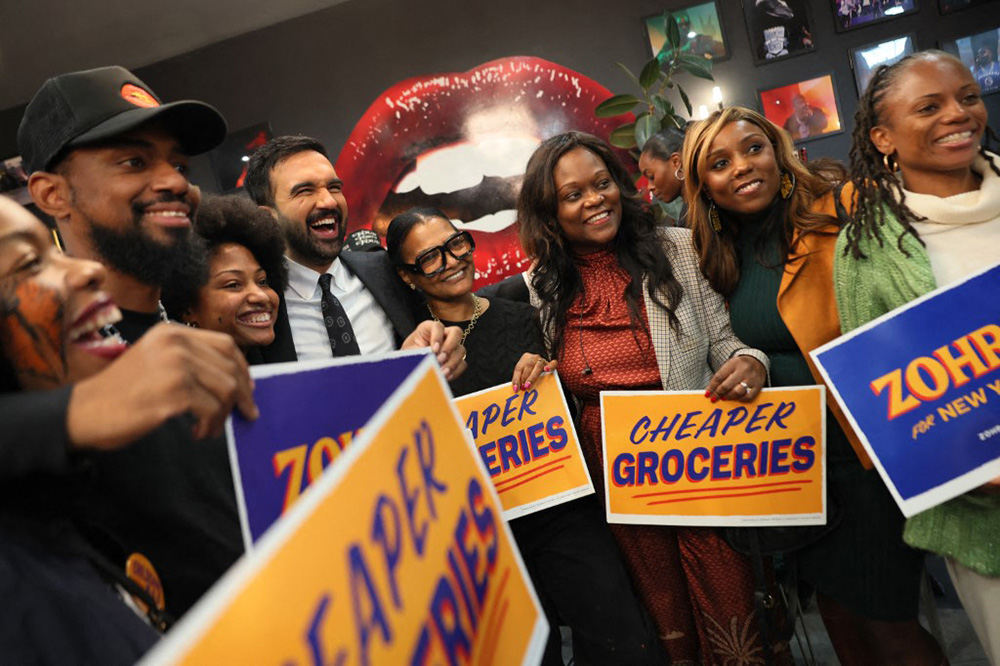 Democratic Mayoral Candidate Zohran Mamdani takes photos with supporters inside of Lips Cafe alongside Assembly member Rodneyse Bichotte Hermelyn and Councilmember Farah Louis on October 25, 2025 in the East Flatbush neighborhood of the Brooklyn borough in New York City. (Michael M. Santiago/Getty Images/AFP)