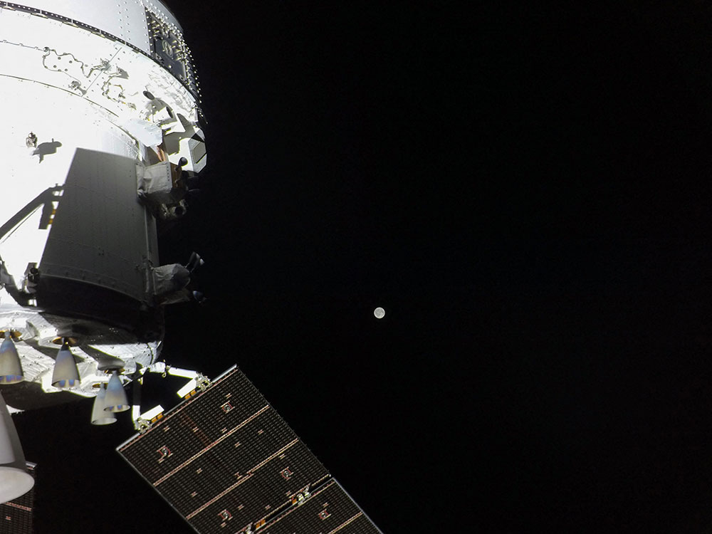 A view of the Orion spacecraft with the Moon in the distance, as captured by a camera on the tip of one of its solar array wings, on April 3, 2026. (AFP/NASA)
