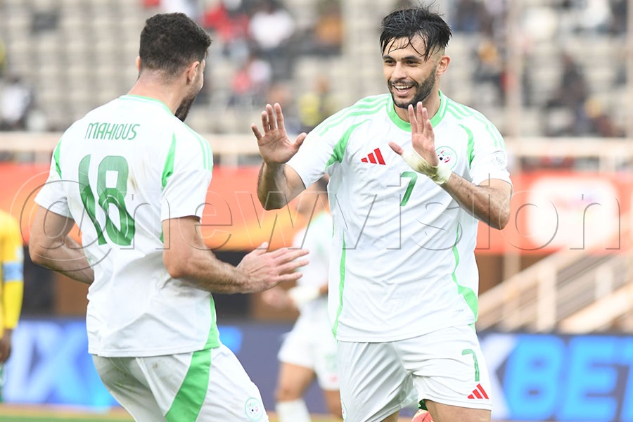 Algeria's Abdennour Iheb Belhocini celebrates his goal against South Africa with Aimen Mahious (left) during a CHAN Group C match at Namboole. Photo by Michael Nsubuga
