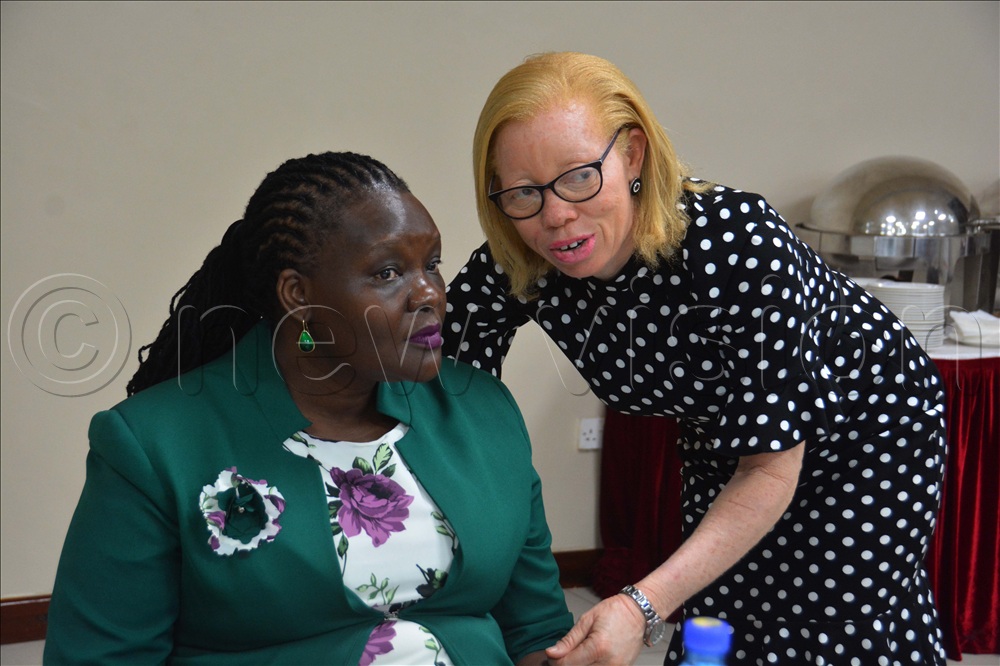 The executive director of Albinism Umbrella, Olive Namutebi (right), interacts with Agnes Nampeera Bulega, the principal rehabilitation officer at the Gender Ministry, during a meeting on the national action plan for persons with Albinism at Hotel Africana in Kampala on Tuesday, July 21, 2026.