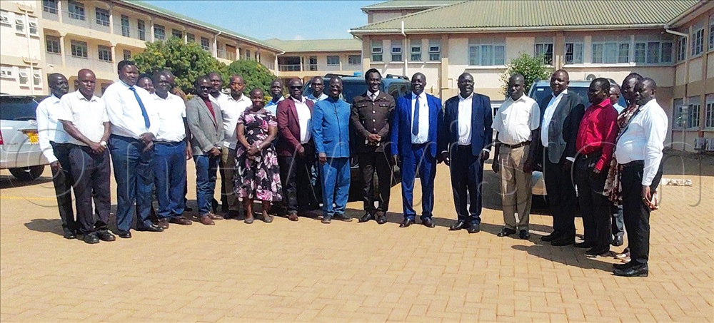 The staff of Muni University with the administrators after handing over the two vehicles for their supervisors.