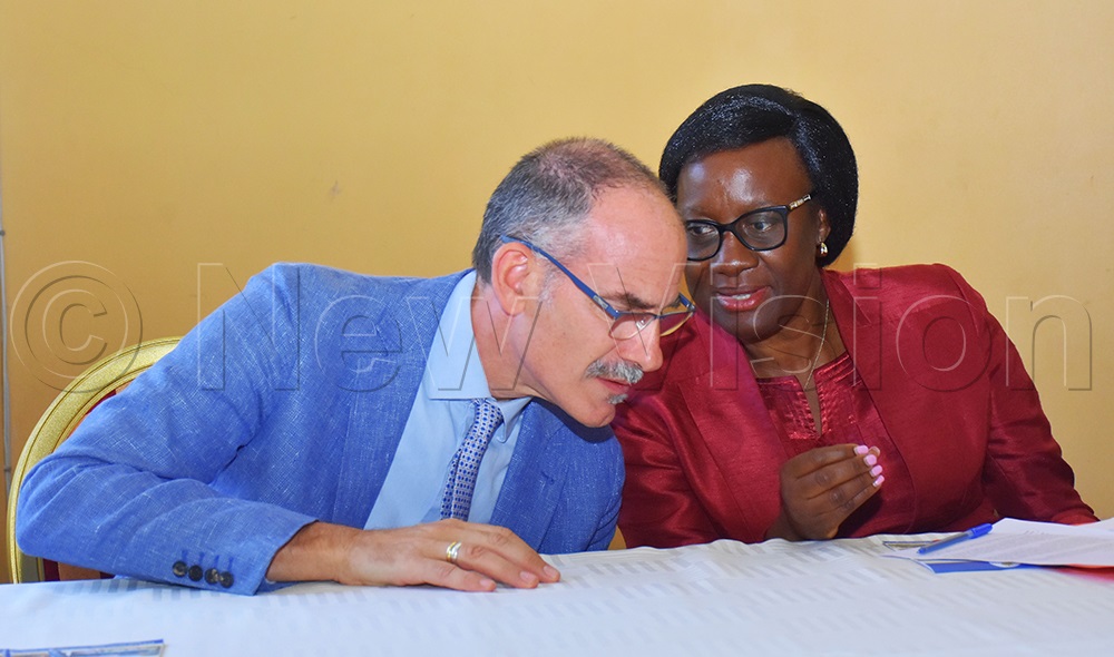 Olive Birungi Lumonya (right) the UCAA deputy director general talking to Cesar Verlarde representing the ICAO director of Air transport bureau during the hand over of SAF report on Monday. (Credit: Julius Luwemba)