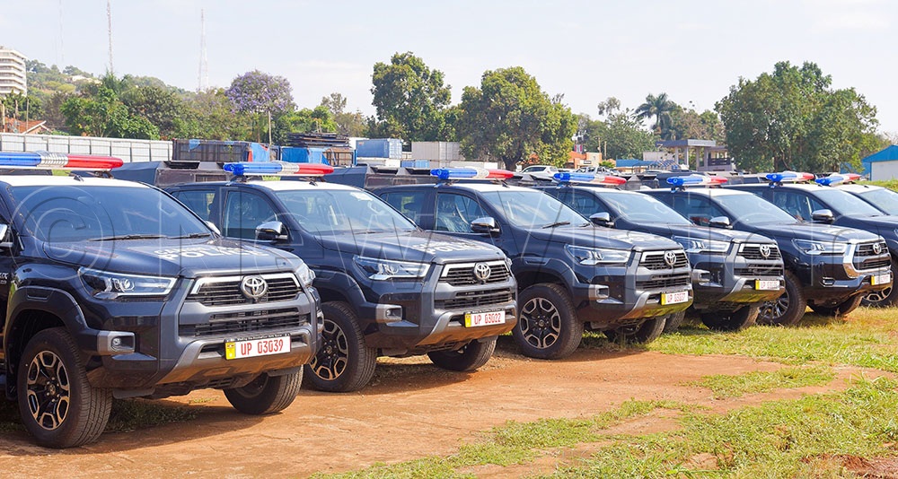 Some of the 10 customised Police Canine Unit vehicles which were handed over by the Deputy Inspector General of Police, Dr. James Ocaya to Dr Martin Mugume (L), the commandant of the Police Canine Unit at Naguru Police headquarters Kampala on September 14, 2026. (Credit: Paul Kiwuuwa)