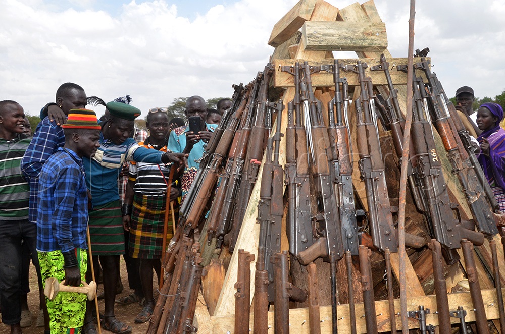 Rehabilitated youths trying to identify their guns before they were burnt. (Photo by Olandason Wanyama)