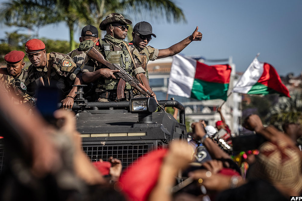 Members of Madagascar’s Army CAPSAT unit react as they are welcomed with jubilation at a civil society rally calling for President Andry Rajoelina’s resignation
