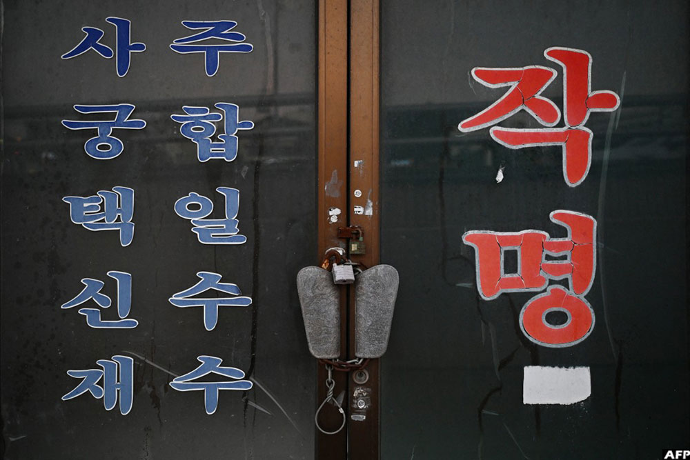 Signs advertising fortune telling services are seen on the door of a closed practice in the &ldquo;Mia-ri fortune-telling village&rdquo; in Seoul